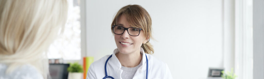 Young female doctor consulting with patient