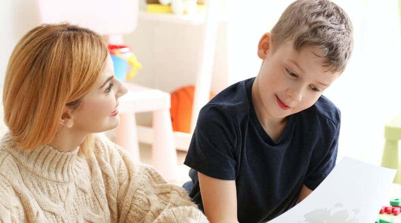 Female psychologist working with boy with autism