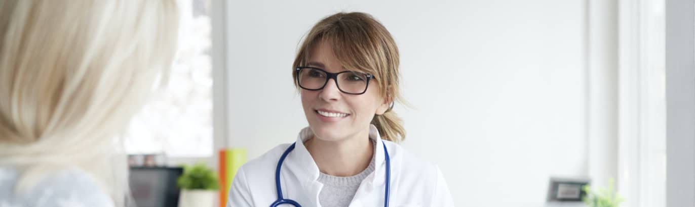 Young female doctor consulting with patient